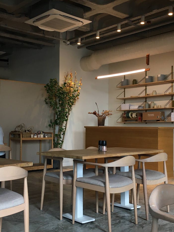 gallery-1 Cozy and stylish café interior in Istanbul, featuring wooden tables and chairs with a minimalist design.