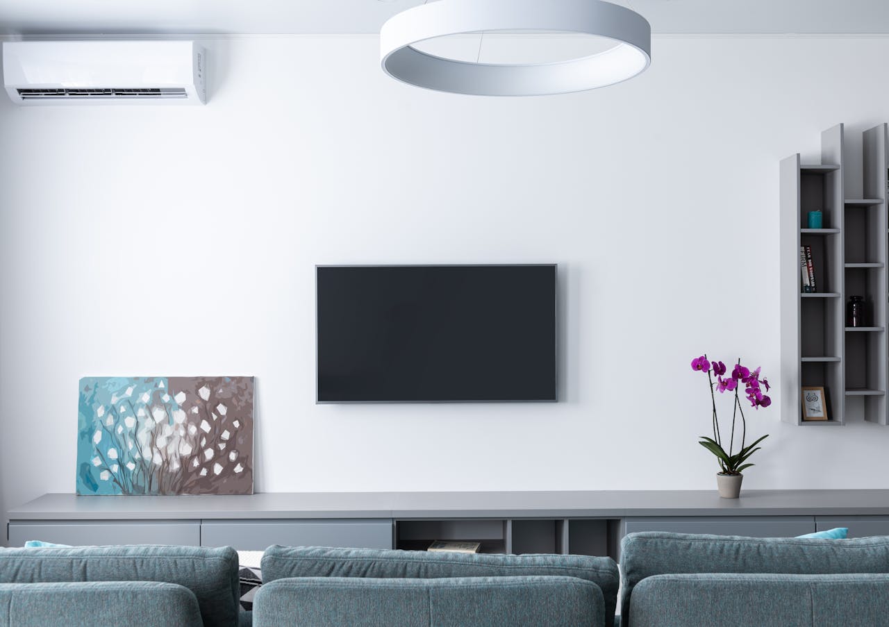 hero-img-01 Contemporary living room decorated with purple flowers and rectangular shaped shelves handing on wall
